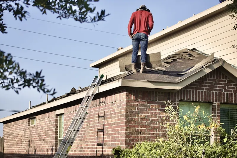 Professional roofer working on a residential roof in Compton